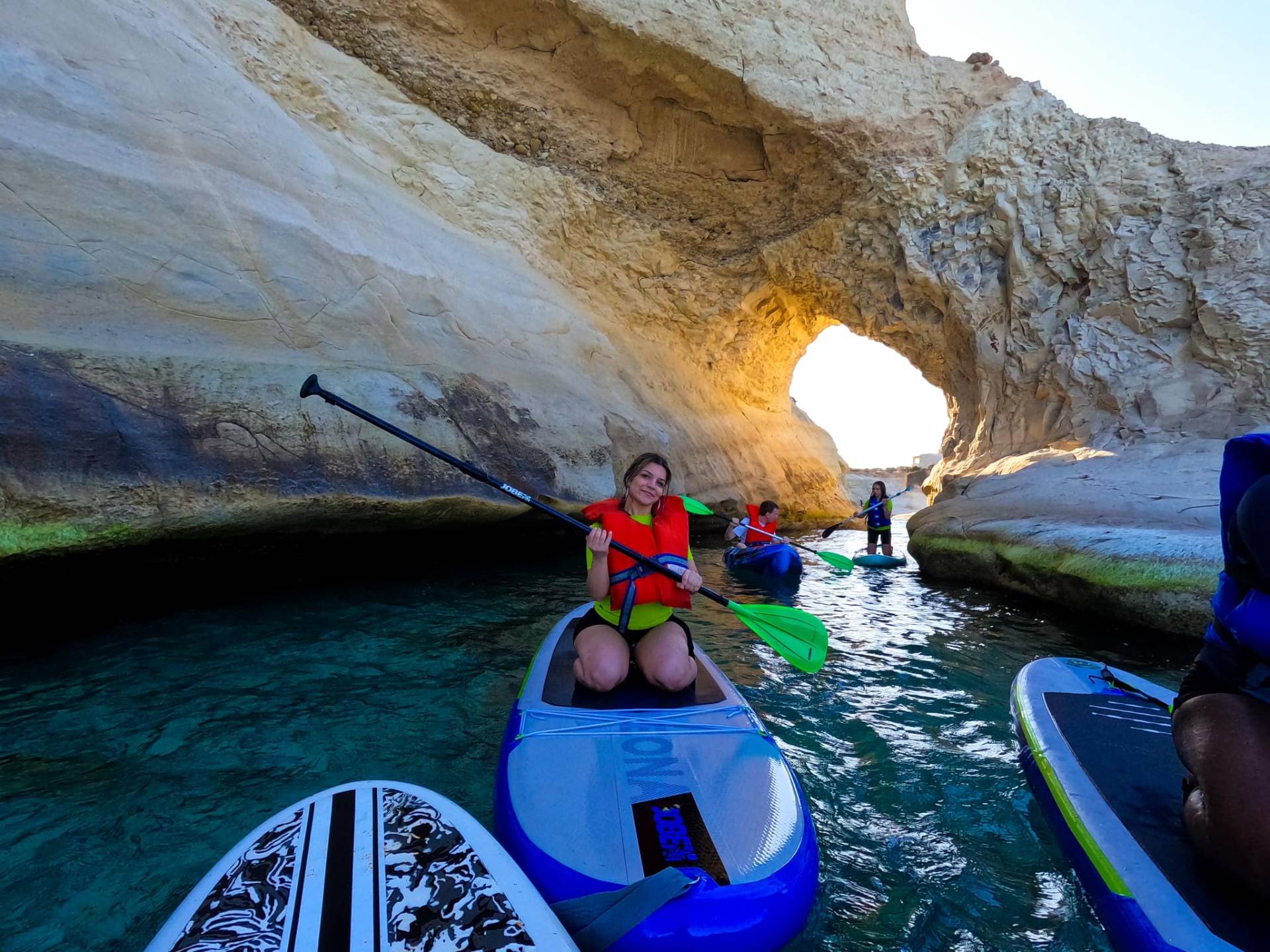 Stand-up paddleboarding near coastal caves